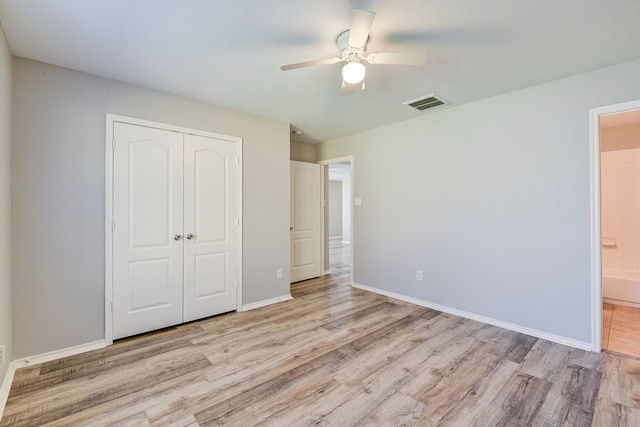 unfurnished bedroom with ceiling fan, light hardwood / wood-style floors, connected bathroom, and a closet