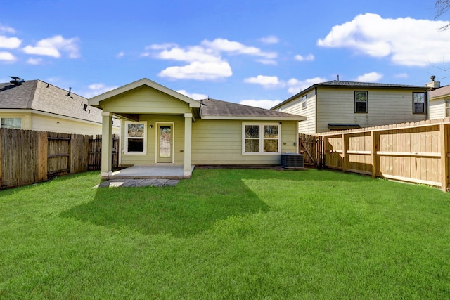 back of property featuring a lawn, a patio, and central AC