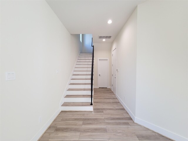 staircase featuring hardwood / wood-style floors