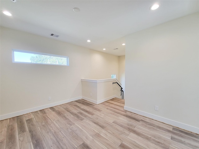 empty room with light hardwood / wood-style flooring