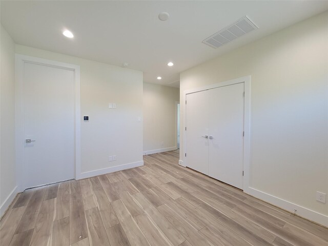 spare room featuring light wood-type flooring