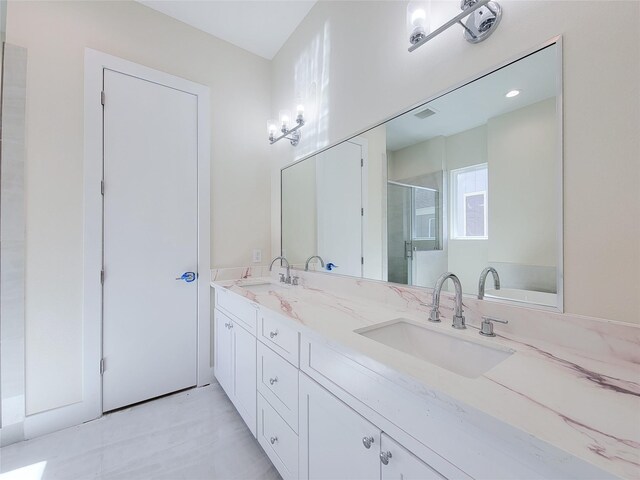 bathroom with vanity and a shower with shower door