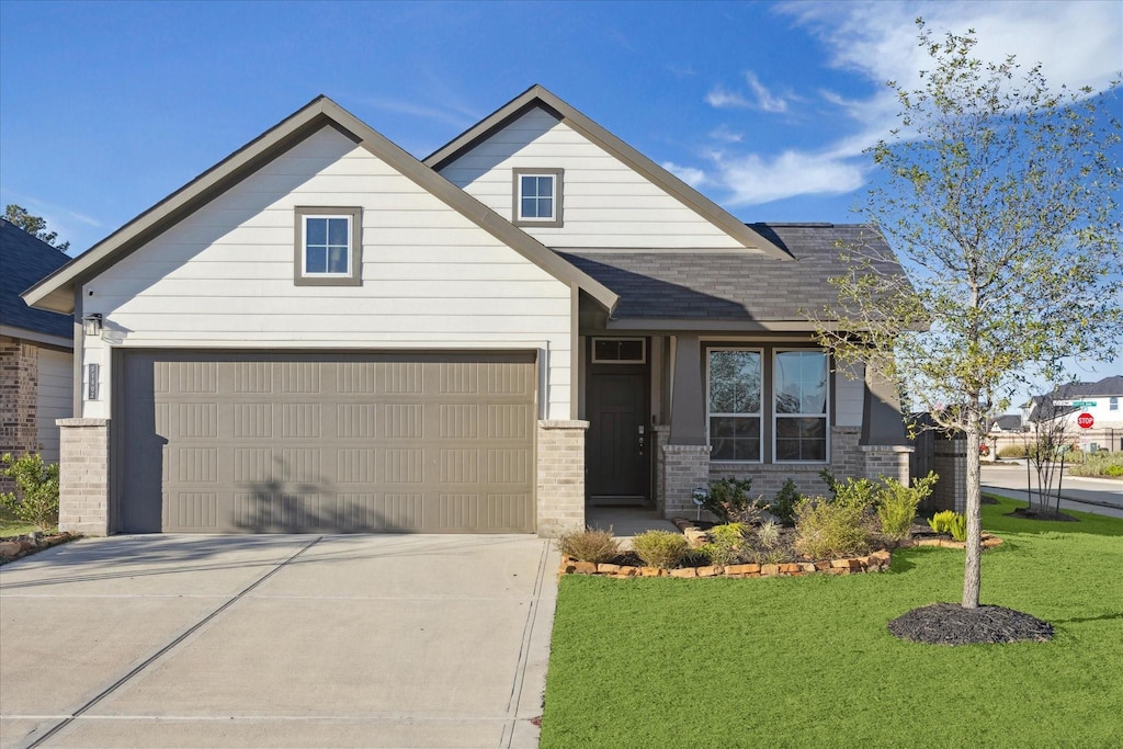 craftsman-style house with a garage and a front lawn