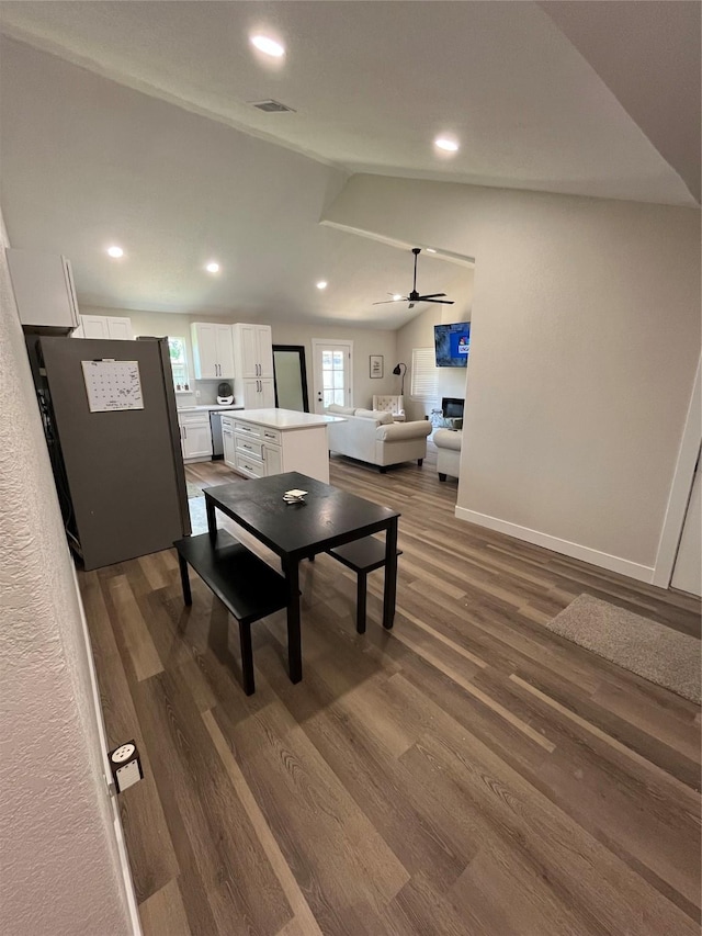 dining room with lofted ceiling, dark hardwood / wood-style flooring, and ceiling fan