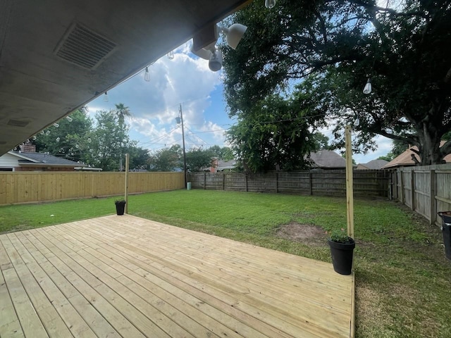 wooden deck with a lawn