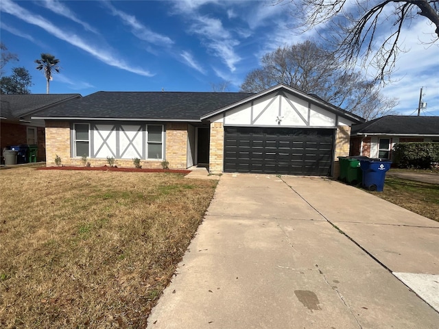 view of front of property featuring a garage and a front yard