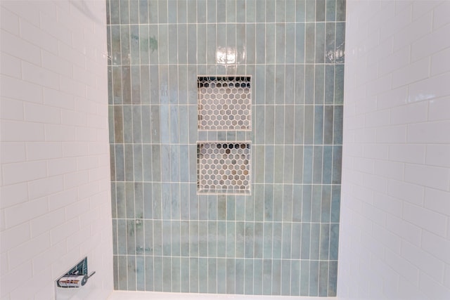 bathroom with a tile shower