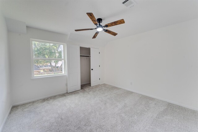 unfurnished bedroom featuring carpet, a closet, and ceiling fan