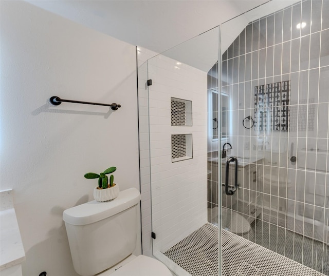 bathroom with an enclosed shower and toilet