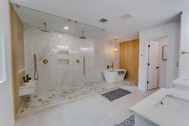 bathroom with vanity and separate shower and tub