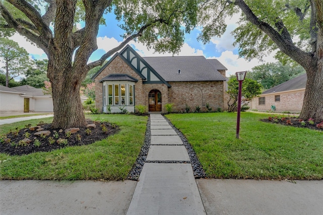 tudor home with a front yard