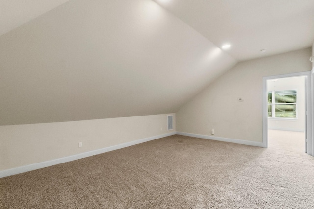 bonus room featuring carpet flooring and vaulted ceiling