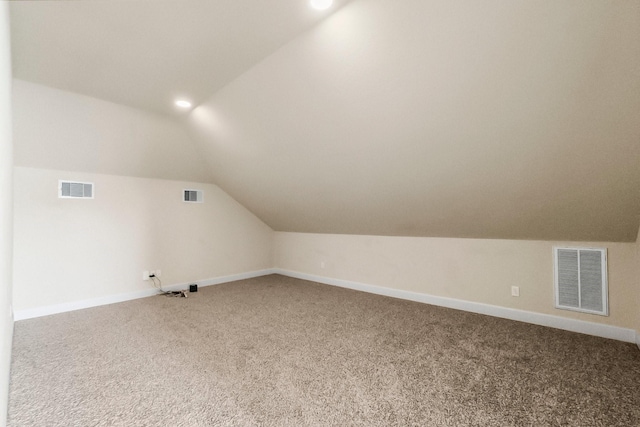 bonus room with carpet flooring and lofted ceiling