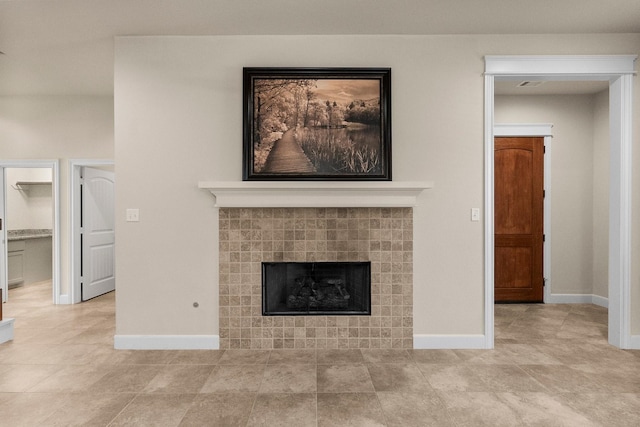 unfurnished living room with a tiled fireplace