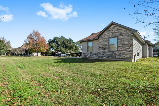 view of side of home featuring a lawn