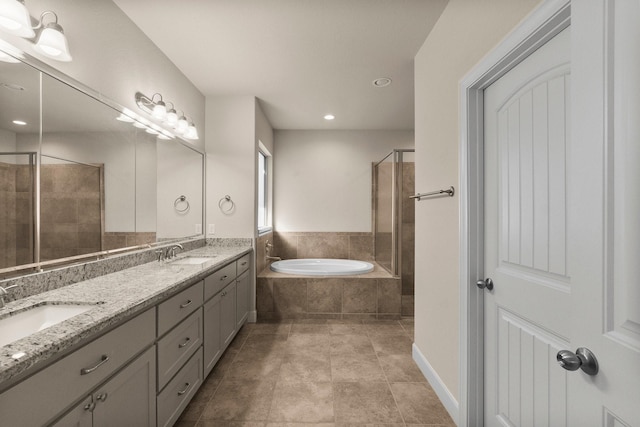 bathroom featuring vanity and independent shower and bath