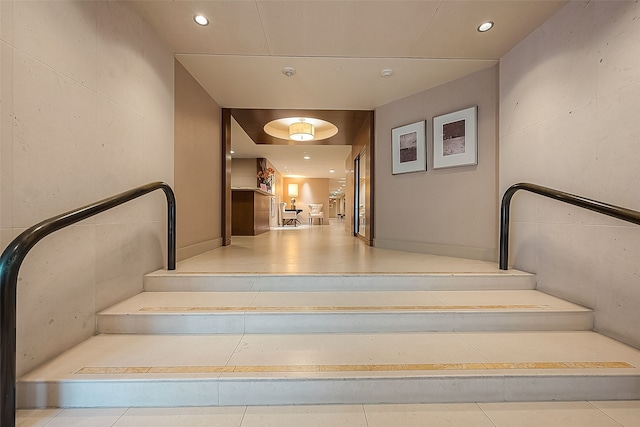 staircase featuring tile patterned flooring