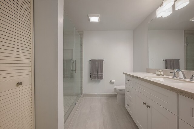 bathroom with vanity, toilet, and walk in shower