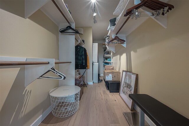 walk in closet featuring light hardwood / wood-style flooring