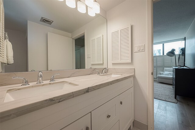 bathroom featuring hardwood / wood-style floors, vanity, and floor to ceiling windows