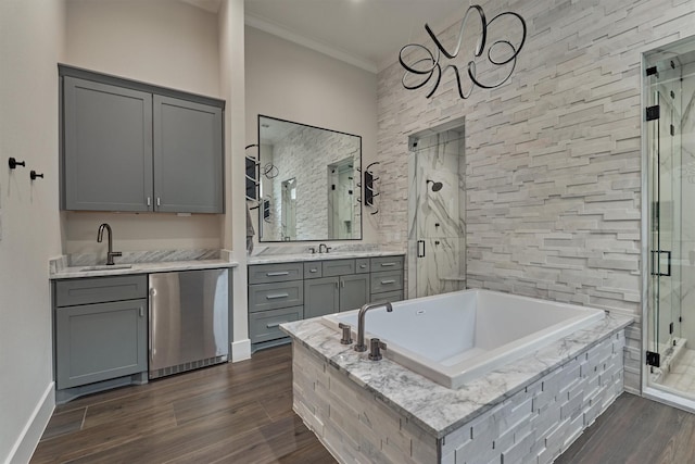 bathroom with vanity, crown molding, and plus walk in shower