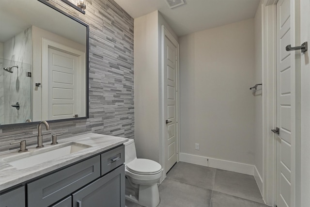 bathroom featuring a shower, vanity, and toilet