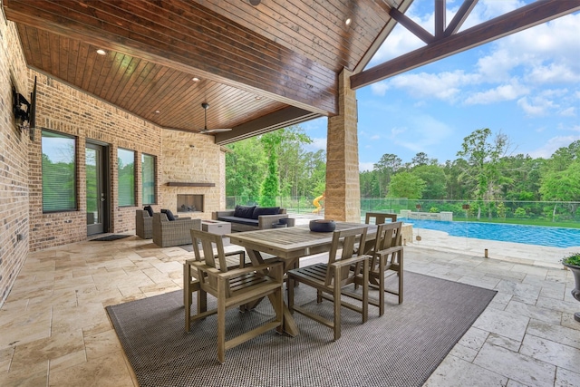 view of patio / terrace featuring an outdoor living space with a fireplace and a fenced in pool