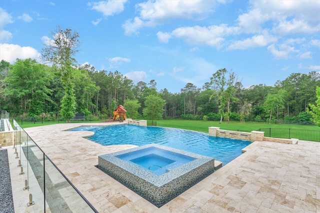 view of pool with a yard, an in ground hot tub, and a patio