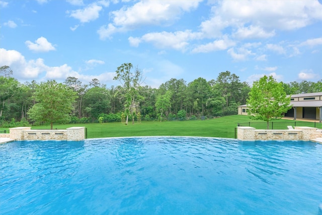 view of swimming pool featuring a yard