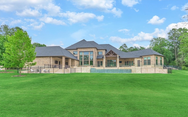 rear view of house featuring a lawn