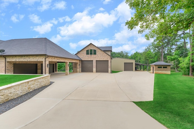 view of front facade featuring a garage, a front lawn, and an outdoor structure