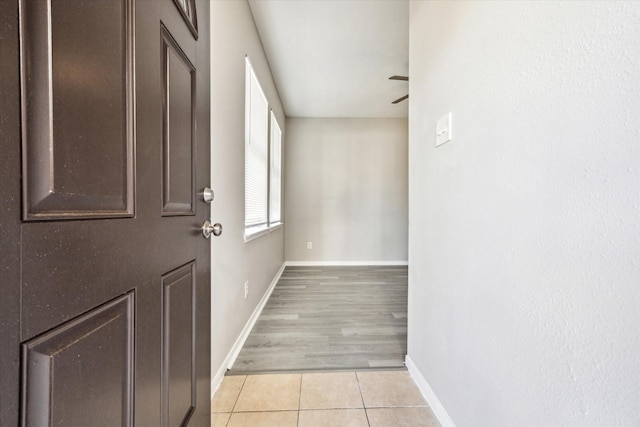 interior space with ceiling fan and light tile patterned floors