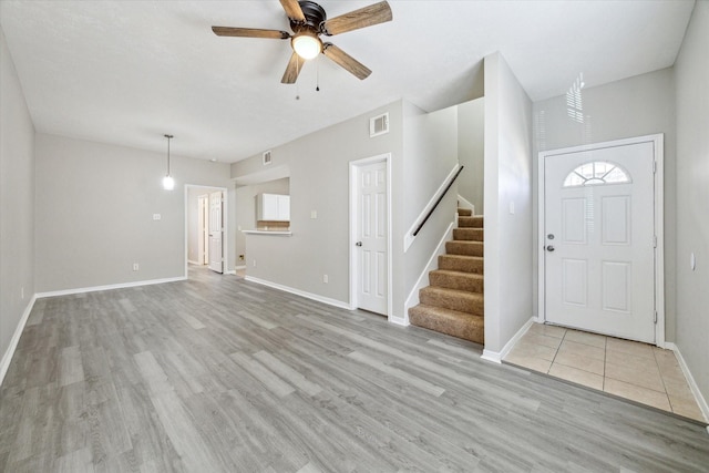 entryway with light hardwood / wood-style floors and ceiling fan