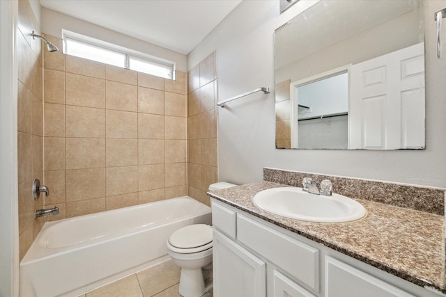 full bathroom featuring tile patterned floors, vanity, toilet, and tiled shower / bath