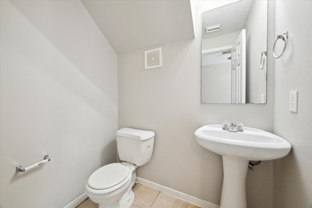 bathroom with tile patterned flooring and toilet