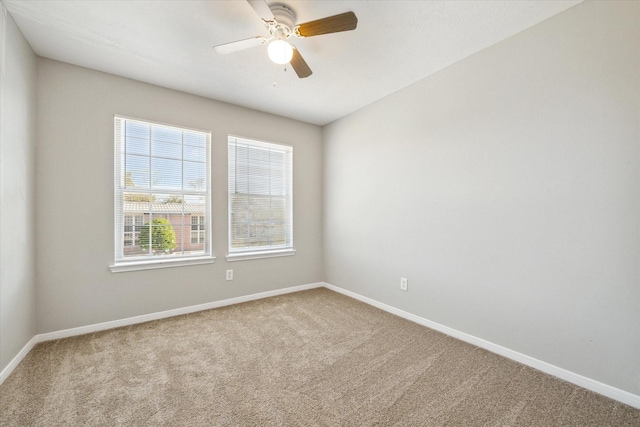 carpeted spare room with ceiling fan