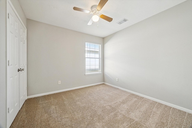 empty room with carpet and ceiling fan