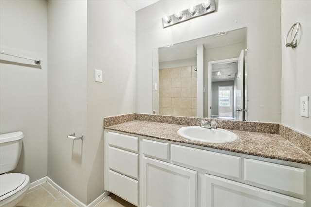 bathroom with tile patterned flooring, vanity, and toilet