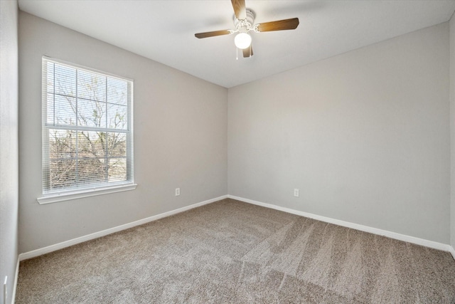 carpeted empty room featuring ceiling fan