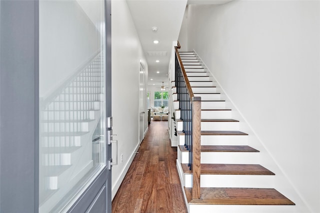 stairway with hardwood / wood-style floors