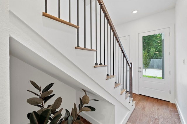 foyer entrance with a healthy amount of sunlight and light hardwood / wood-style floors