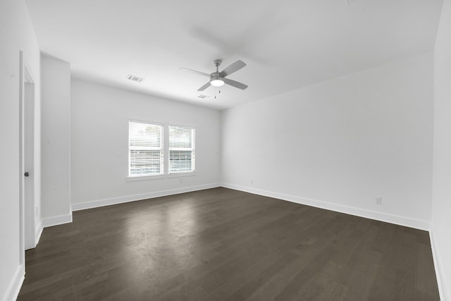 unfurnished room with ceiling fan and dark wood-type flooring