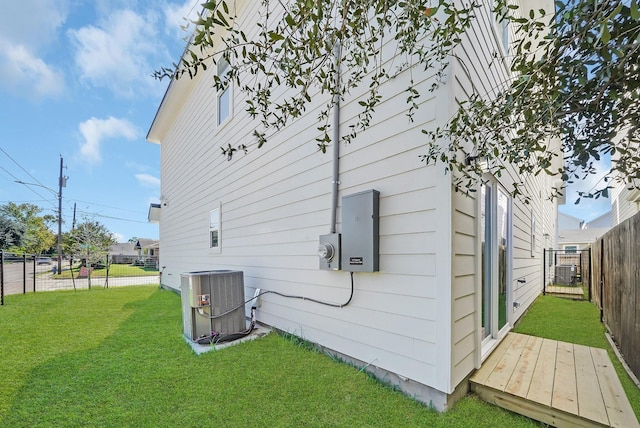 view of home's exterior with a yard and cooling unit