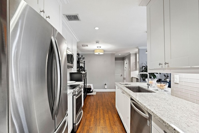 kitchen with sink, white cabinets, and appliances with stainless steel finishes