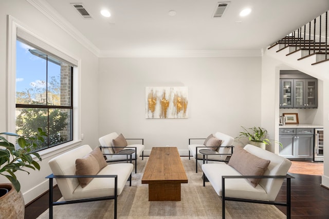 interior space featuring indoor bar, dark hardwood / wood-style floors, wine cooler, and crown molding