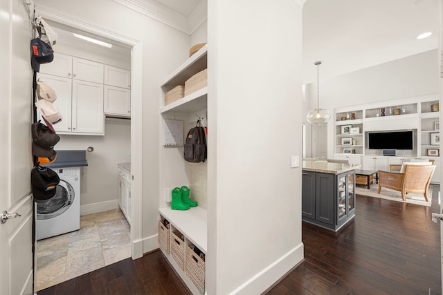 interior space featuring dark hardwood / wood-style flooring, washer / dryer, and ornamental molding