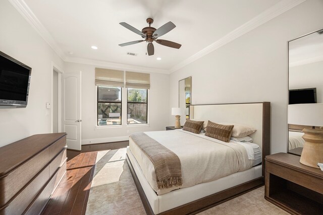 bedroom featuring ceiling fan, light hardwood / wood-style flooring, and ornamental molding