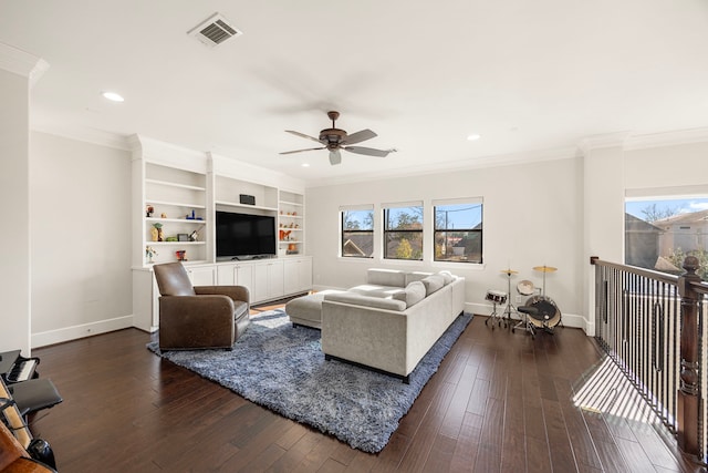 living room with dark hardwood / wood-style floors, ceiling fan, and crown molding