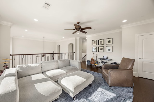 living room featuring ceiling fan, dark hardwood / wood-style flooring, and crown molding