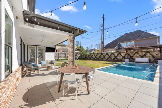 view of swimming pool featuring outdoor lounge area, french doors, pool water feature, and a patio